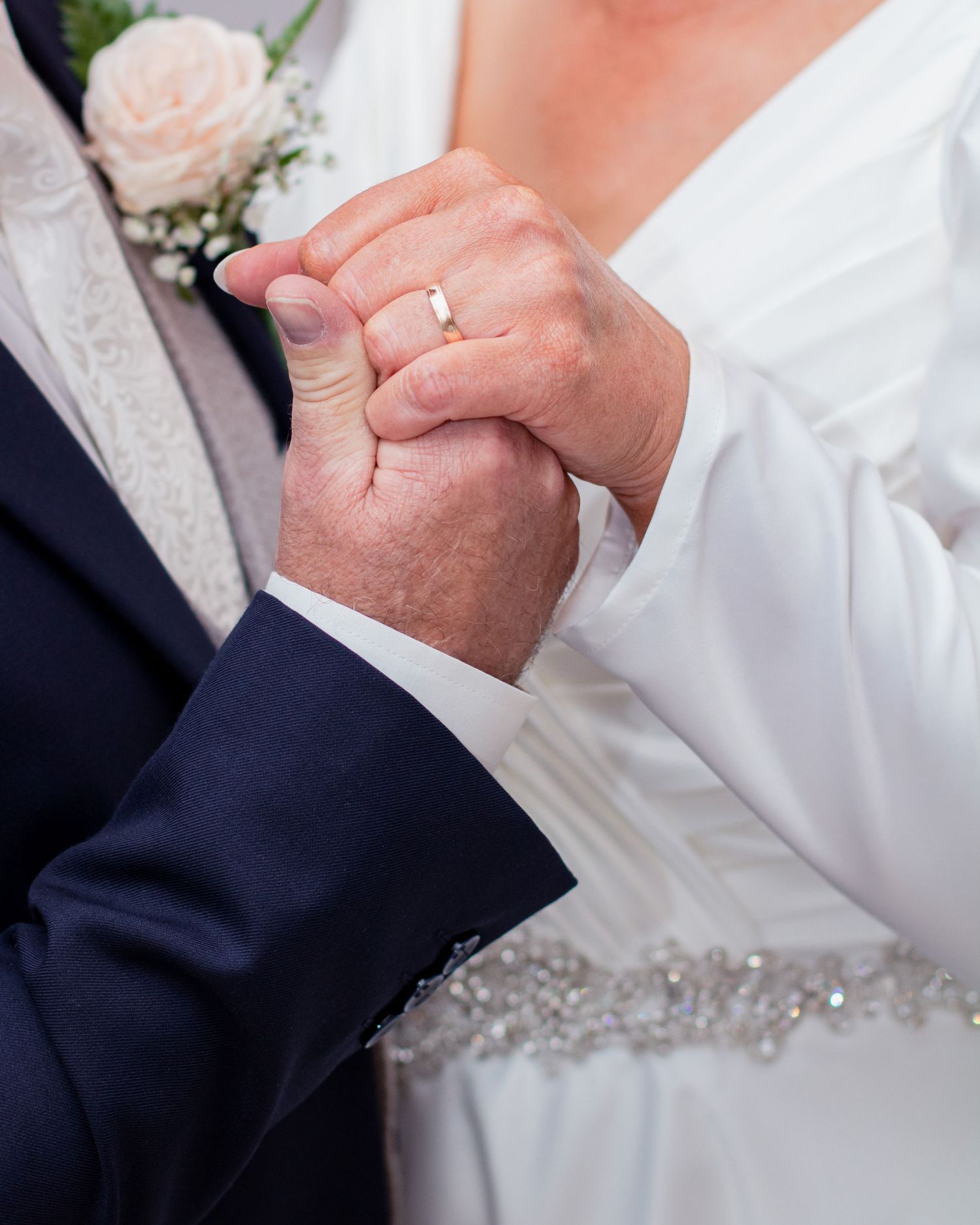 Close-up shots of wedding couple's hands and rings during ceremony.