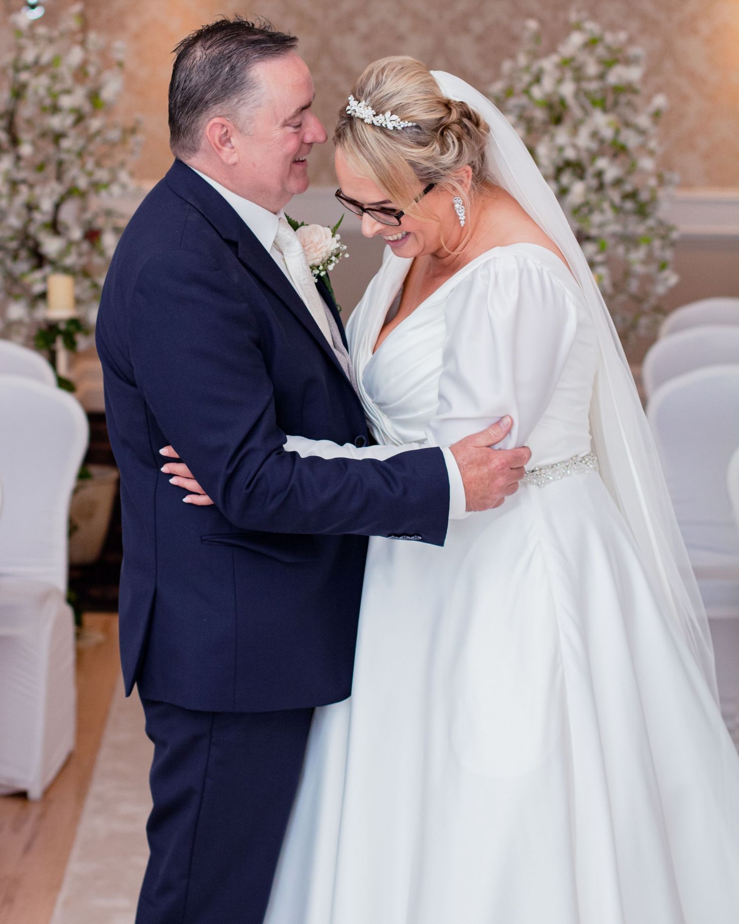 Wedding couple sharing romantic moments in an elegant indoor venue.