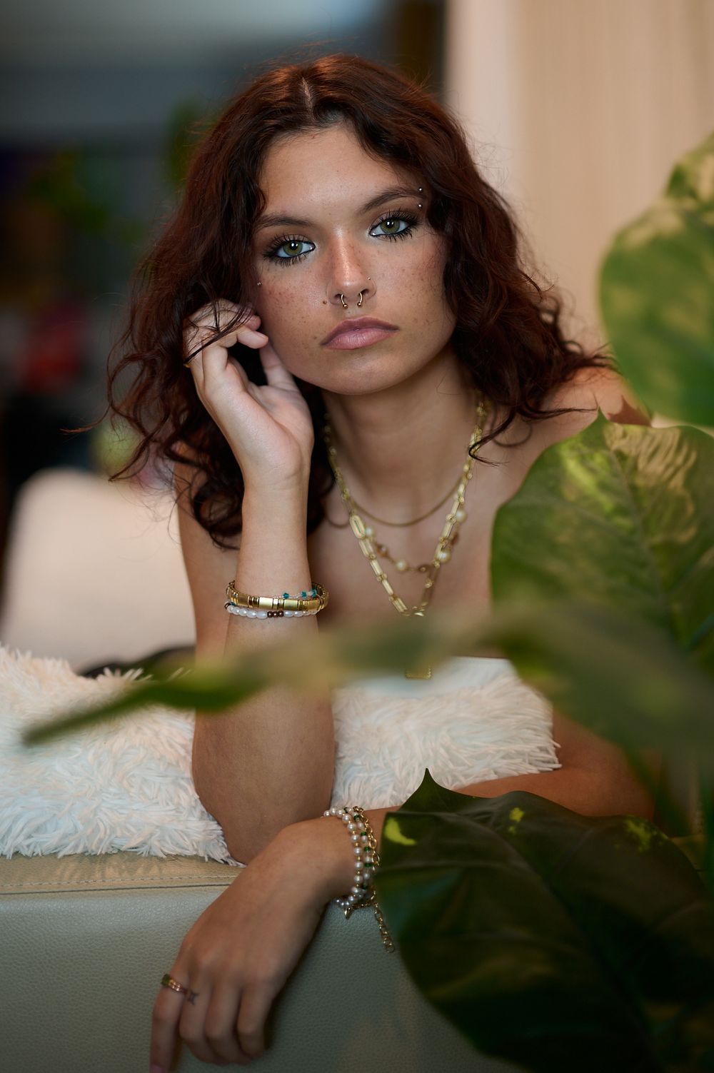 Artistic portrait series through foliage features elegant jewelry and soft lighting effects.