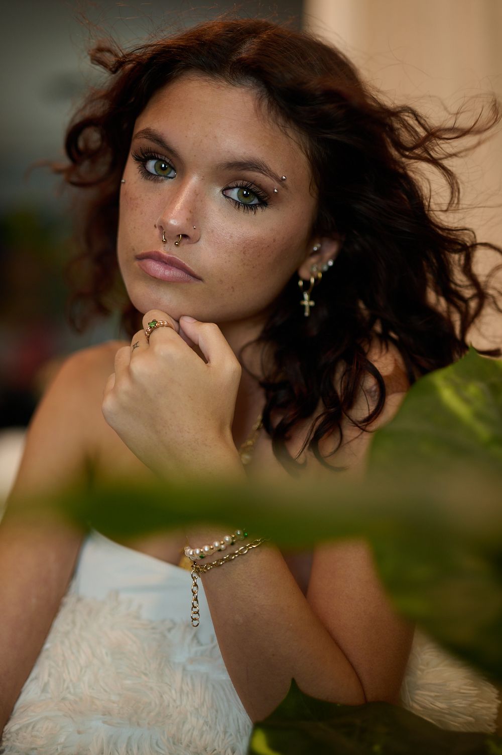 Romantic portrait sequence with delicate jewelry and natural foliage framing the composition.