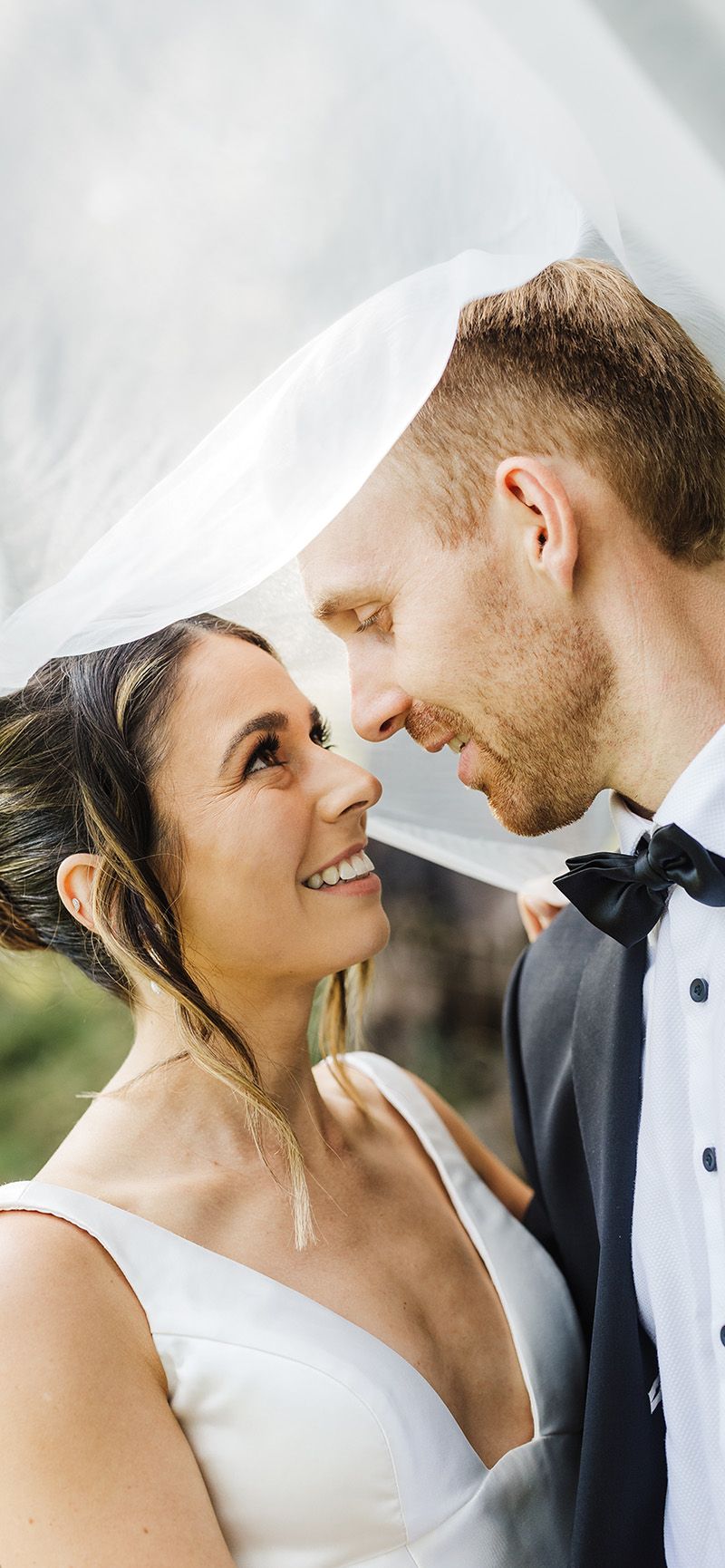 Intimate close-up portrait under flowing white veil from Kate Lafferty Photography