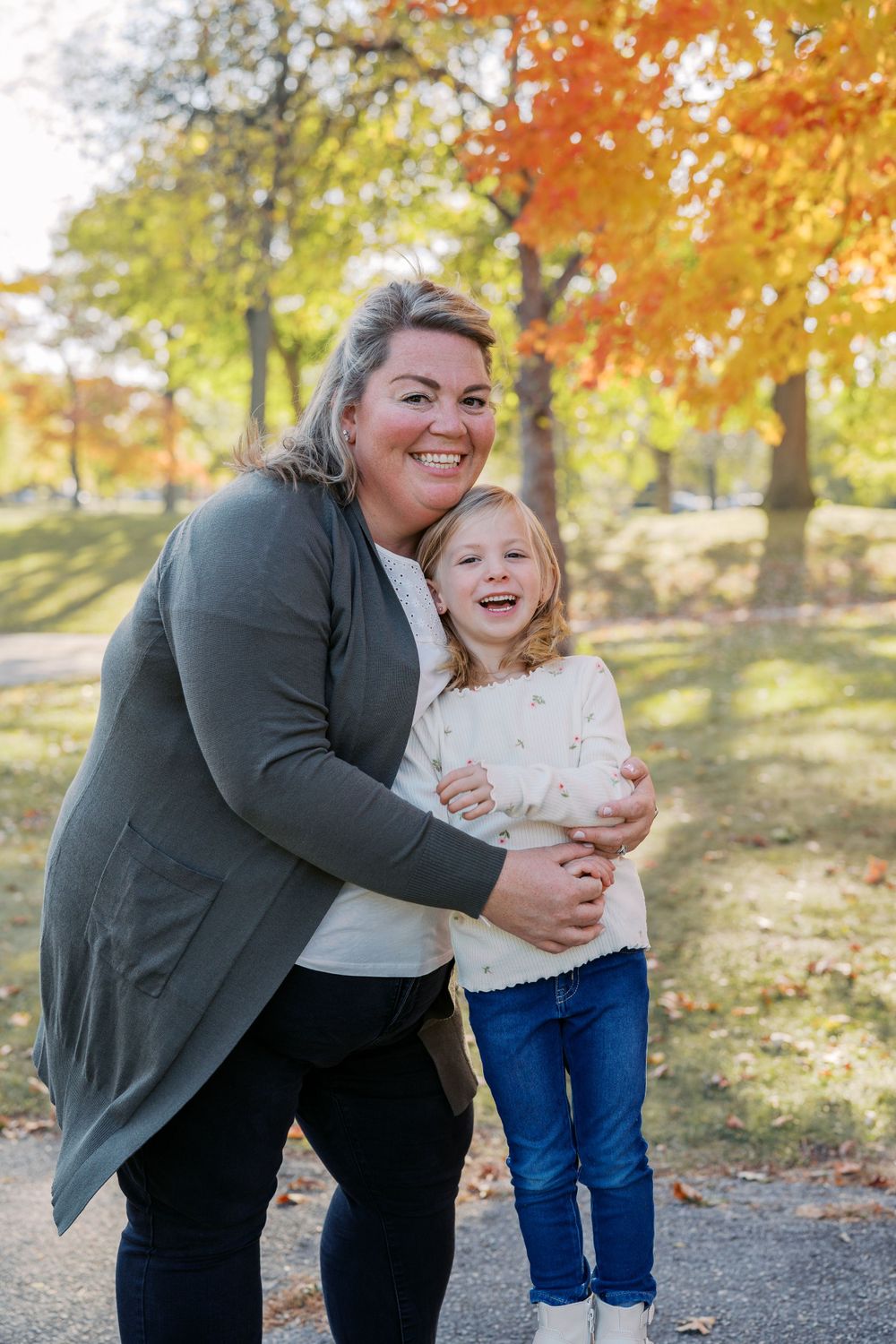 Joyful outdoor portrait with beautiful fall colors in background.