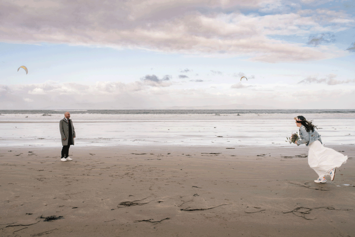 Bride and groom at sunset in the beach running towatds each other in County Sligo, captured by Dina Ozola Photography