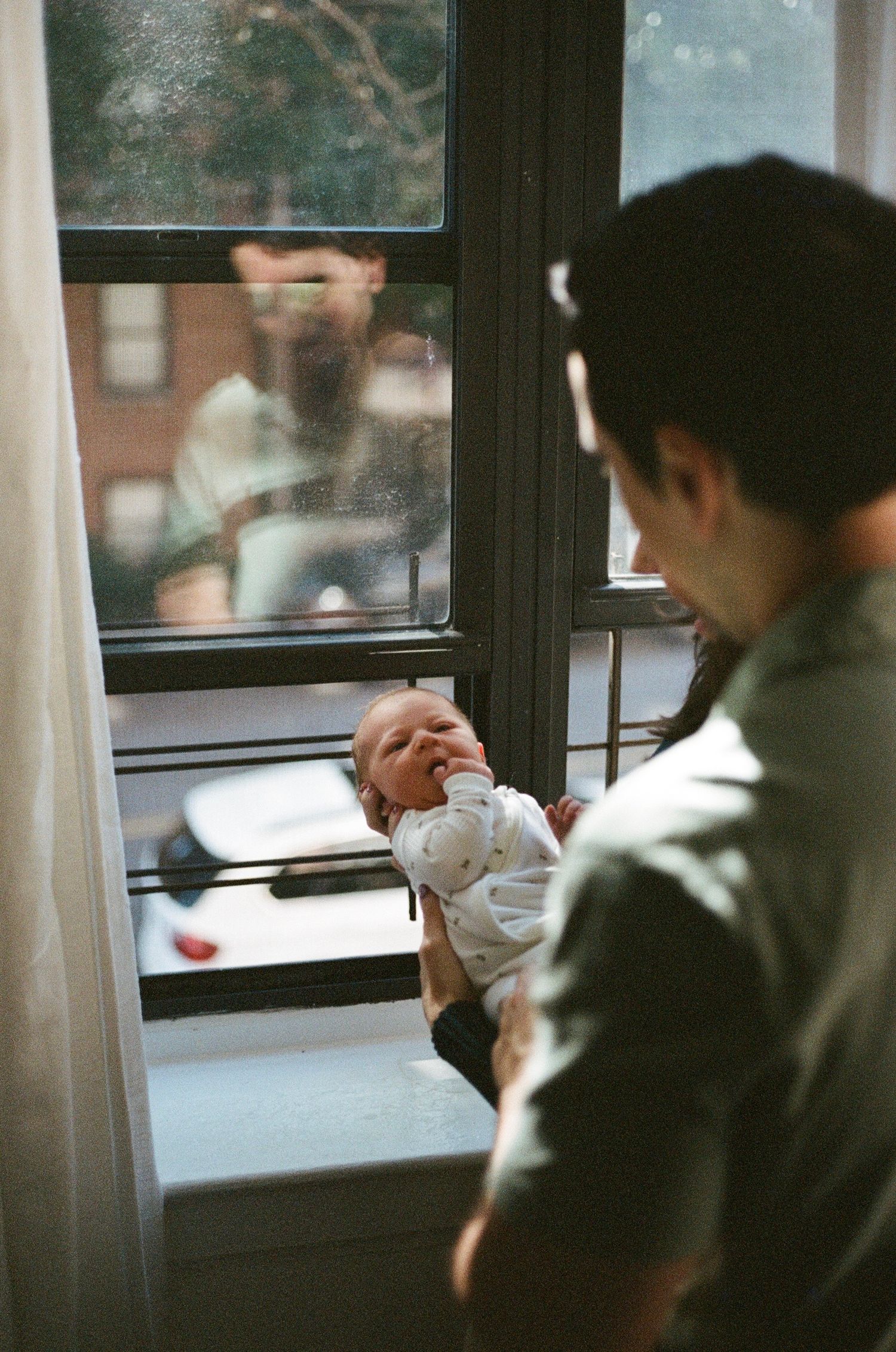 film maternity photography in New York City with soft natural light and intimate, emotional connection