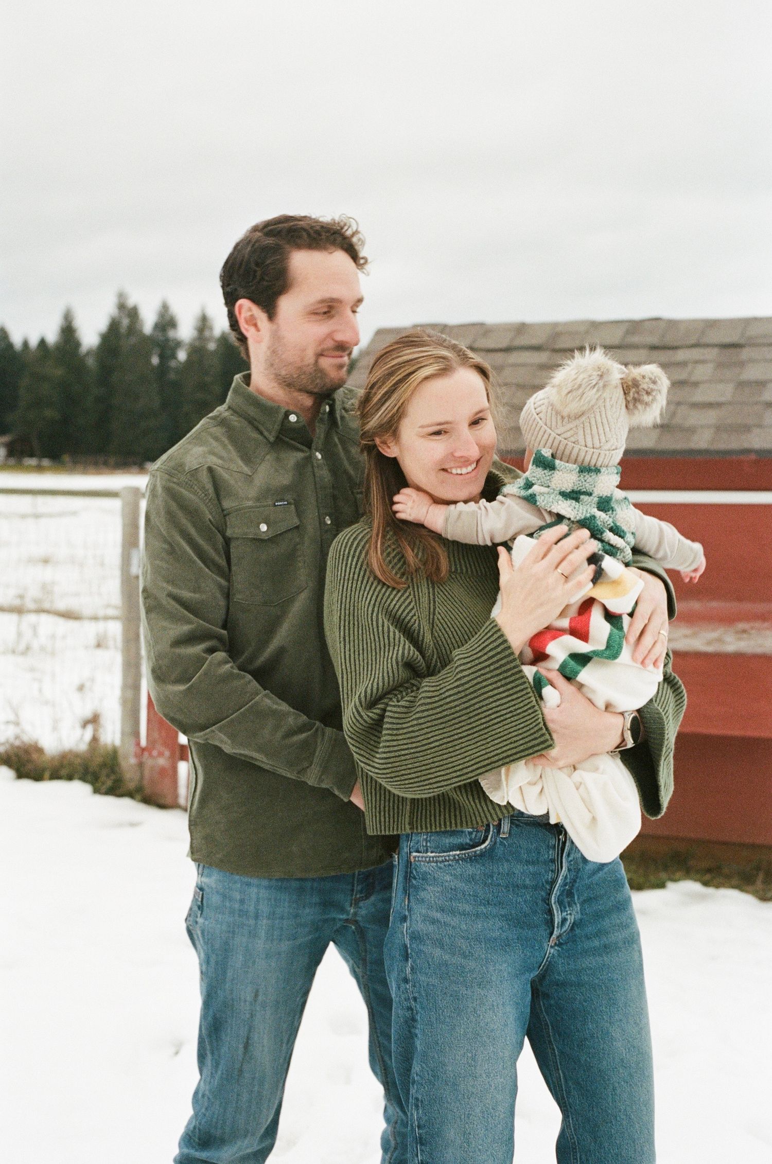 natural light newborn photography with parents and baby, soft film tones and emotional connection
