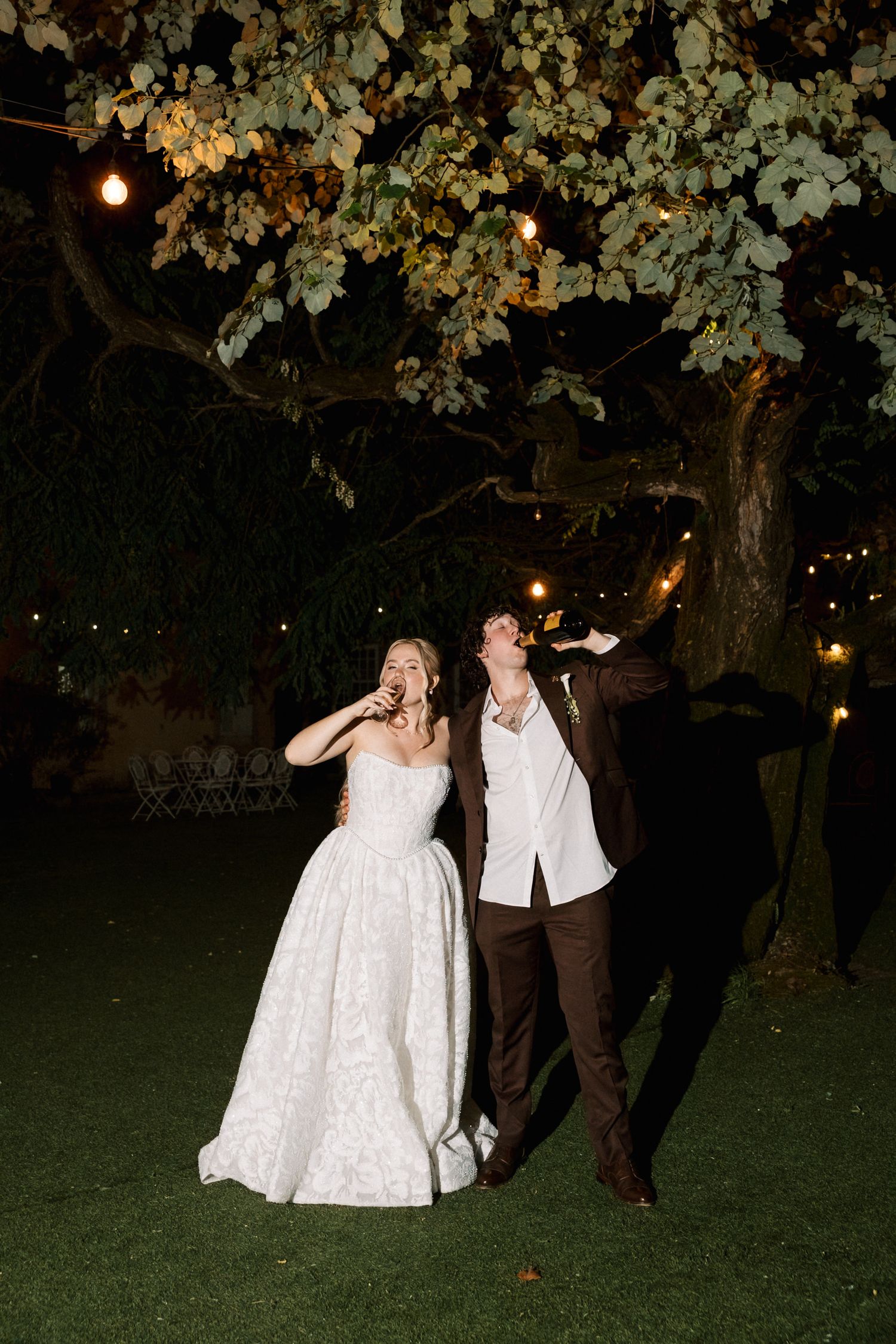 Bride and groom celebrating beneath the lights at Quinta do Torneiro