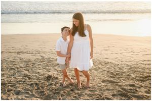 Sayulita family photoshoot, mother and son walking at golden sunset beach, soft natural light lifestyle moment.