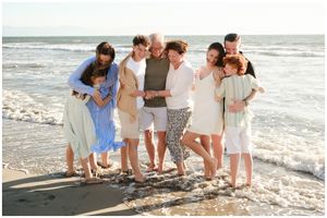 Multi-generational family smiling on Sayulita beach, Sayulita family photographer, waves at feet, candid natural light session.