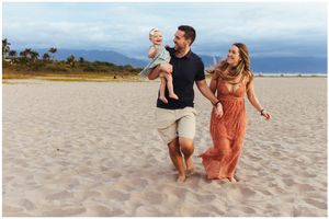 Family photoshoot in Sayulita beach, Mexico, barefoot walking with baby, mountains and ocean, family photographer Riviera Nayarit.