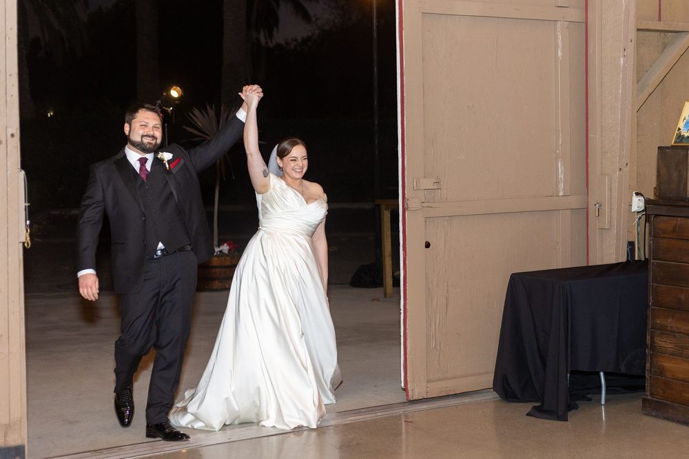 Celebratory entrance of newlyweds into their wedding reception venue.