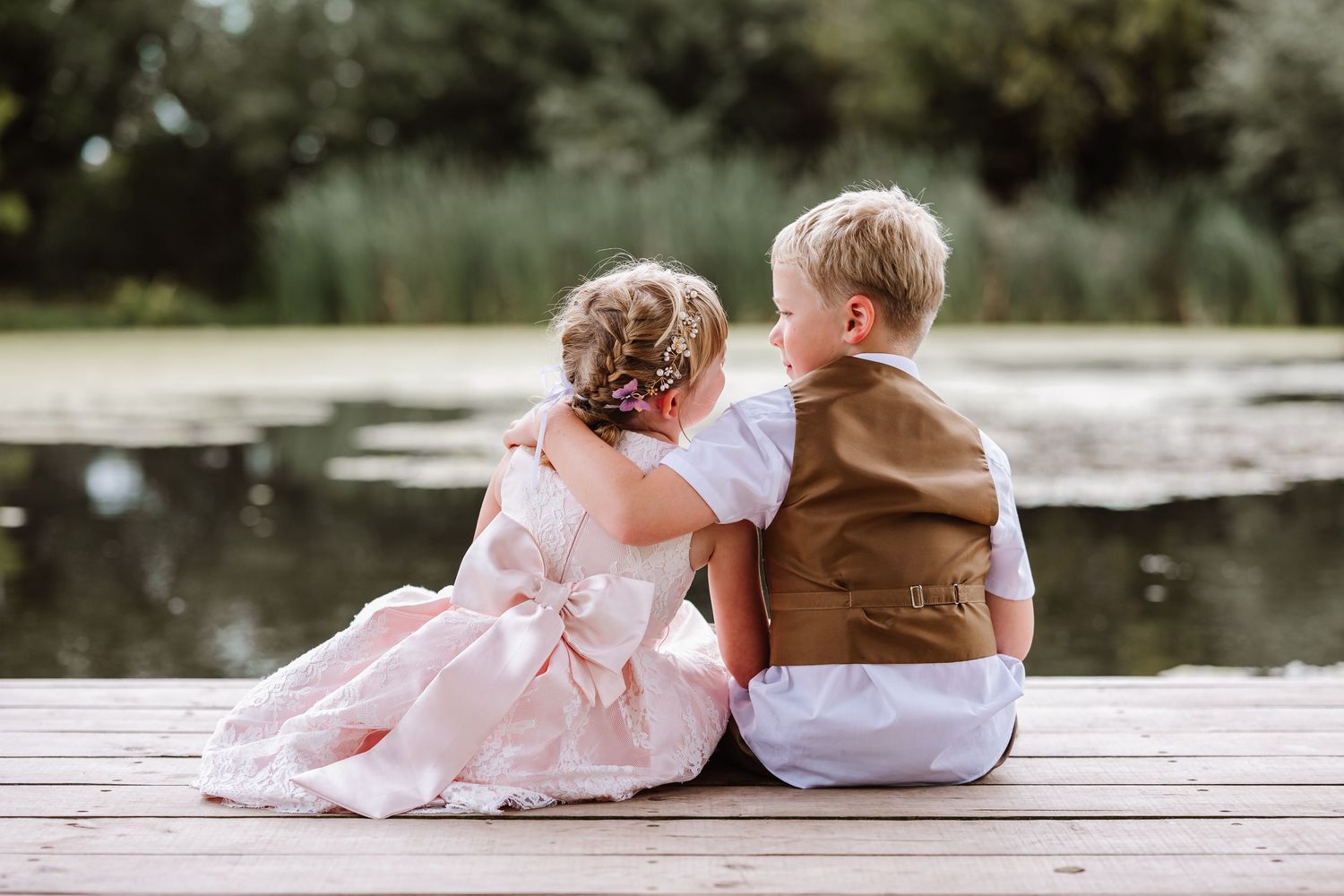 Children hug at the Waterside Country Barn and Mill wedding venue in Taunton.