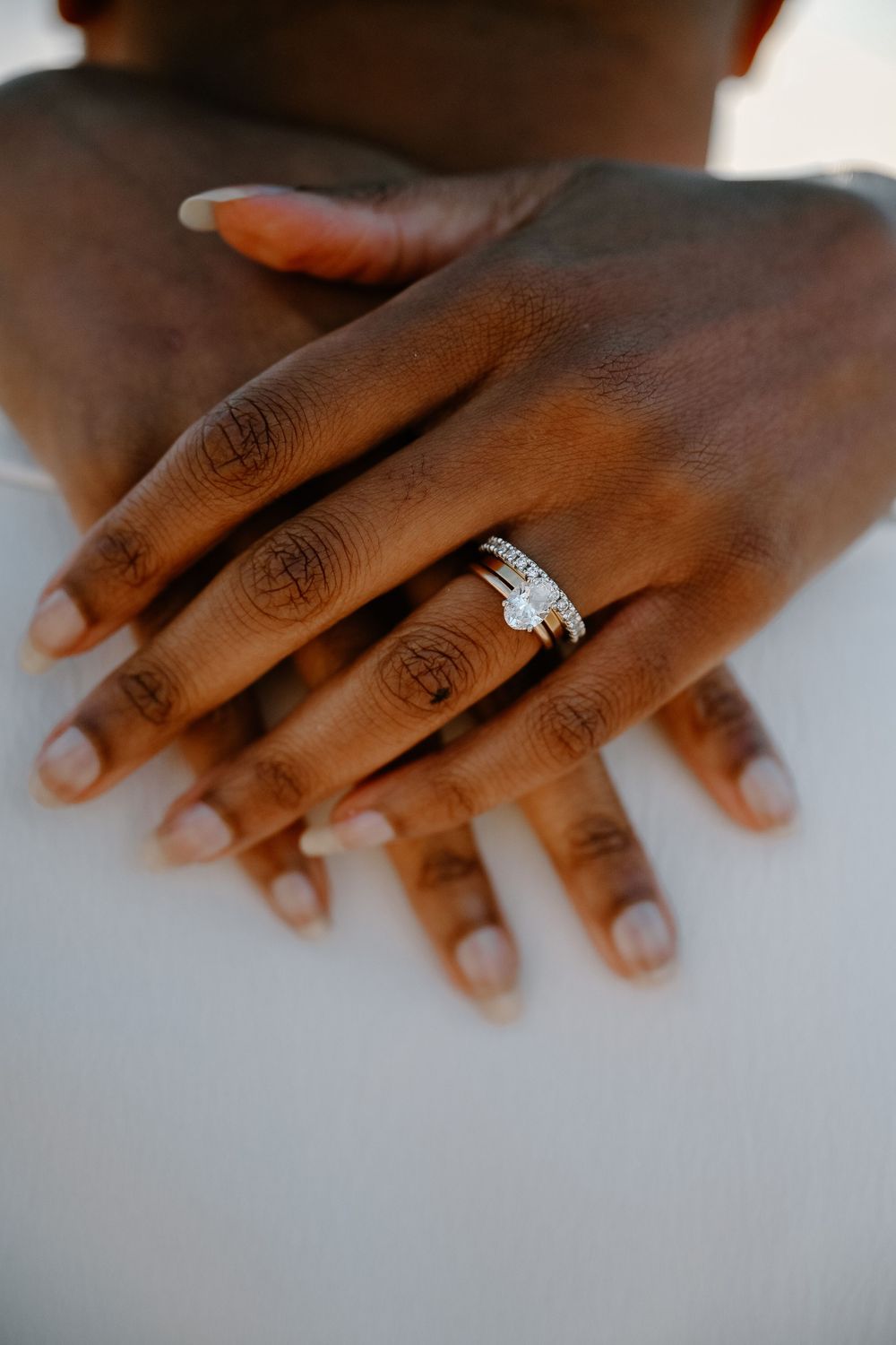 A series of close-up shots showing a diamond engagement ring on a person's hand from different angles.