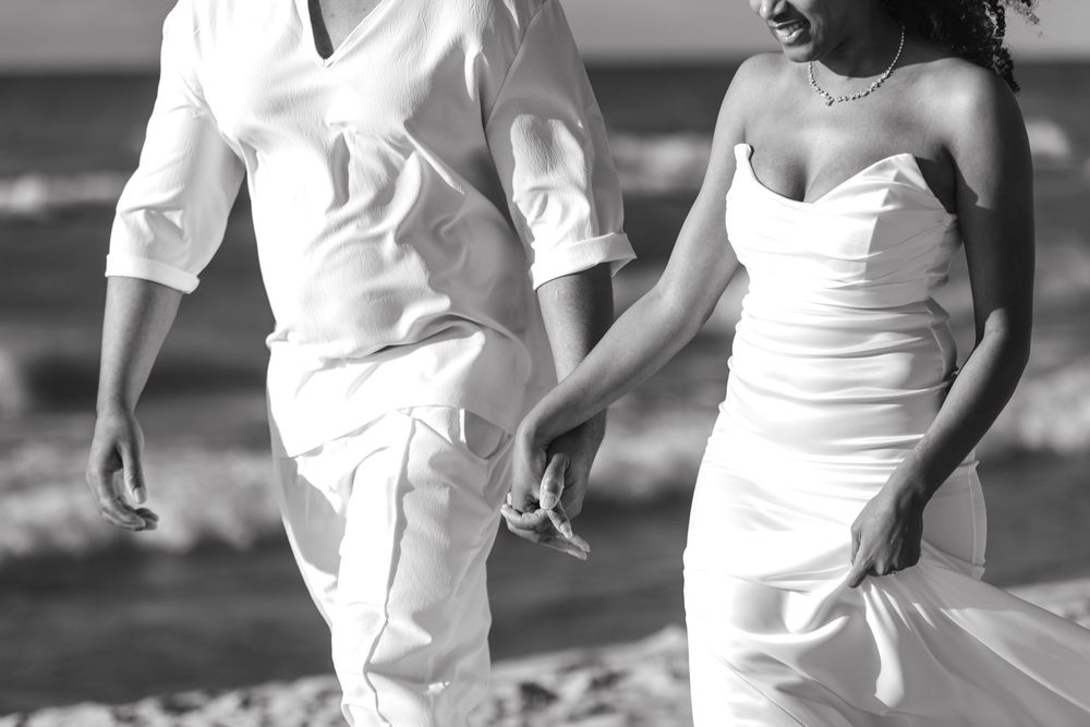 A black and white photo sequence showing the movement of two people dancing together in white outfits.