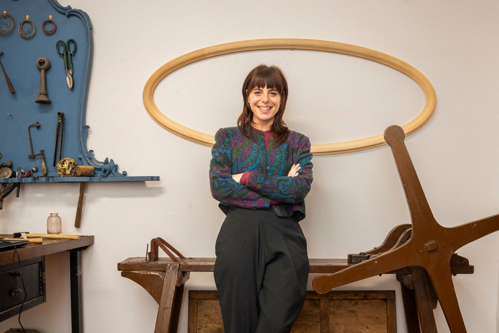 Environmental portrait of a designer in a curated Florence creative space; brand retainer imagery for local jewelry and fashion brands.