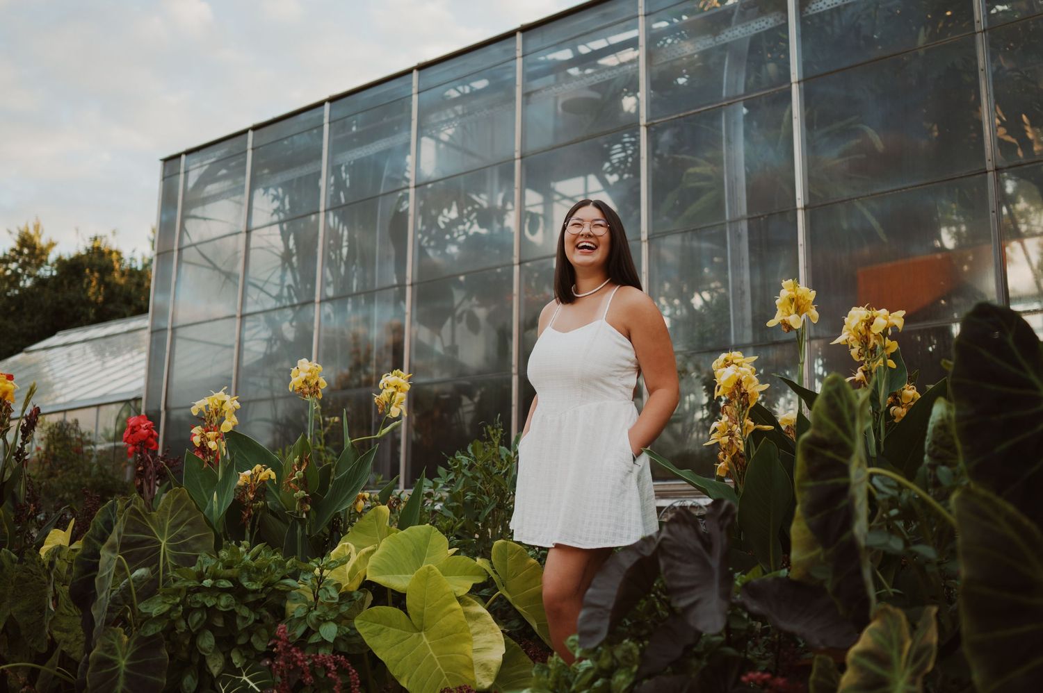 A series of greenhouse photos showing a person posing among yellow daffodils and lush greenery at different angles.