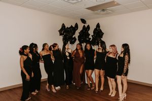 A collage of people in black attire gathered in different poses and formations against a white wall.