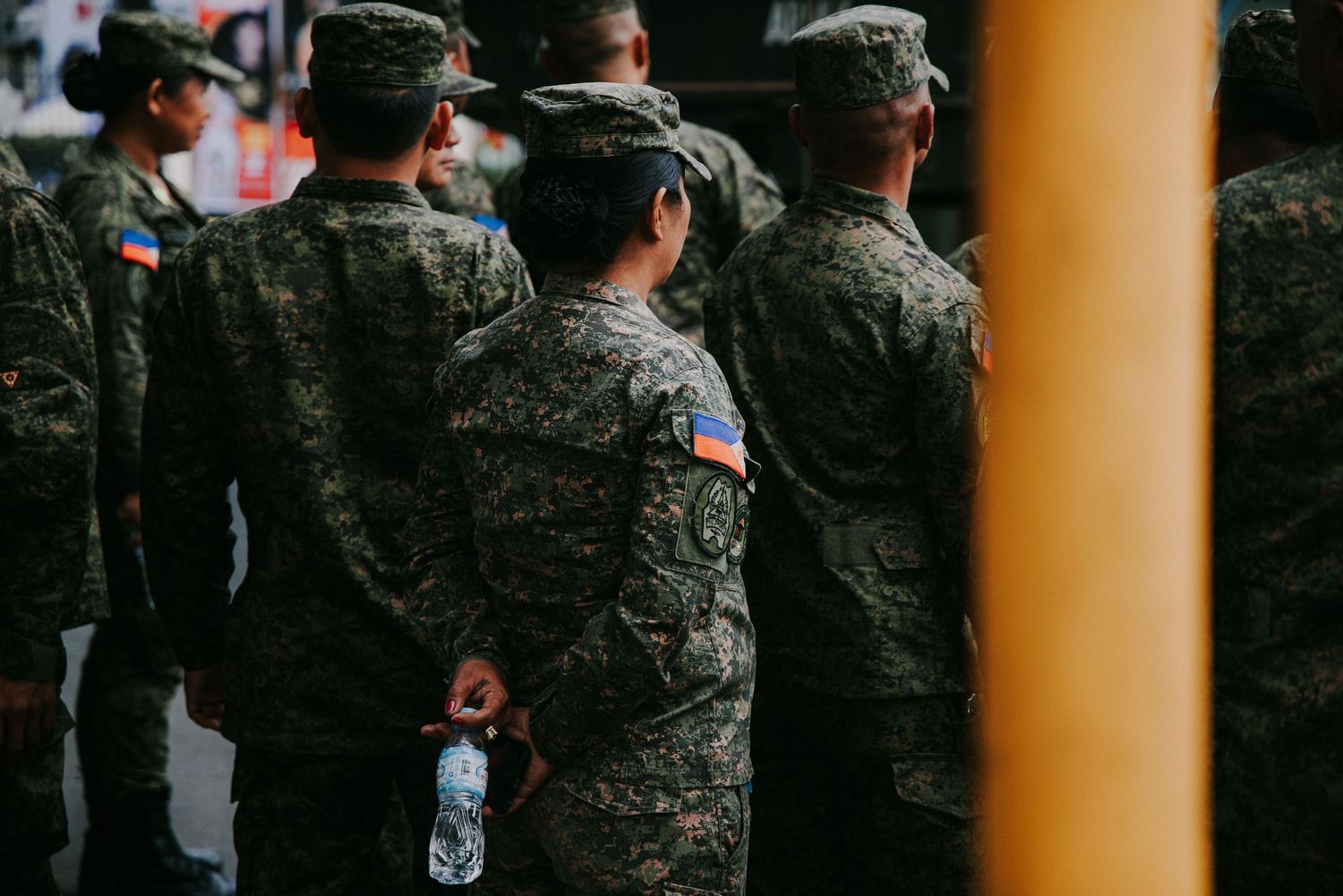 Military personnel in camouflage uniforms standing in formation.