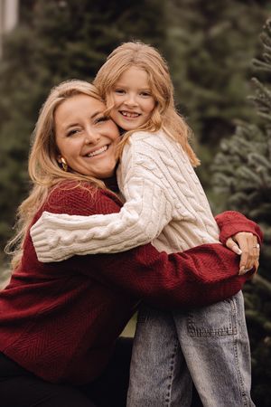 A heartwarming sequence of photos showing a tender embrace between two people wearing cozy sweaters in a natural setting.