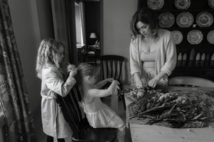 A collection of vintage-style black and white photographs showing quiet domestic moments in dimly lit interiors.