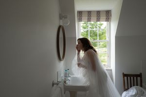A series of four connected photos showing a light-filled room with windows and interior home renovation progress.