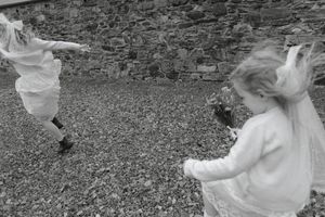 A black and white photo sequence shows a person falling backwards while attempting to use a swing set.