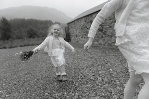 Black and white photo series showing a child running and playing in a grassy field.