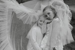 Black and white photo series showing a bride in a romantic tulle gown posing elegantly in different positions.