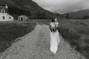 A series of black and white panoramic landscape photos featuring a white horse and figure in a dress on a rural path.