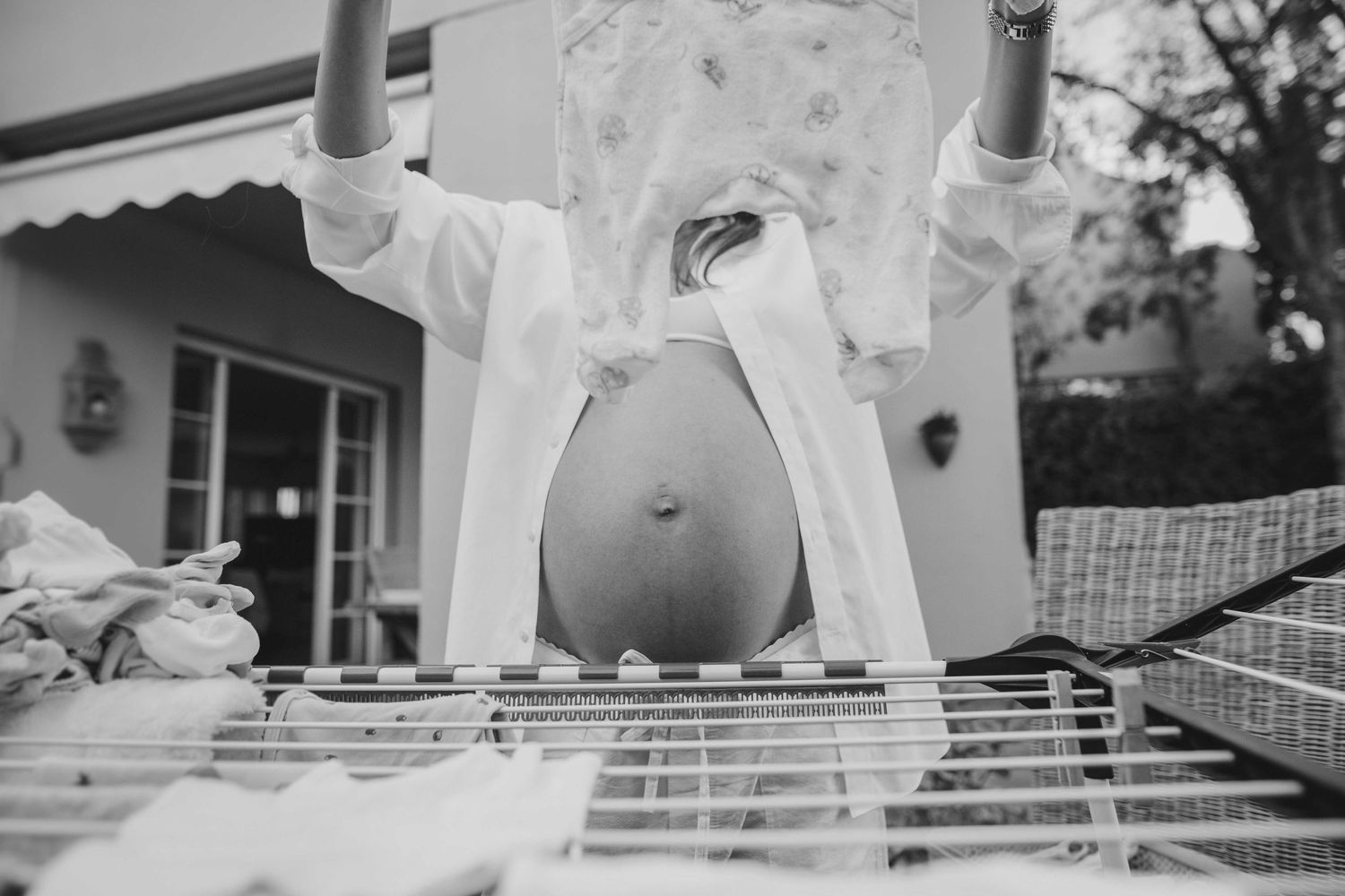 A black and white photo series showing different angles of a bride and groom during their wedding celebration.