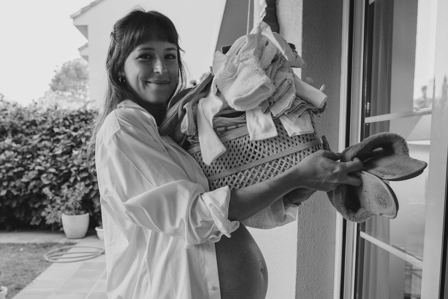 A series of black and white photos showing intimate moments between parent and baby at home.