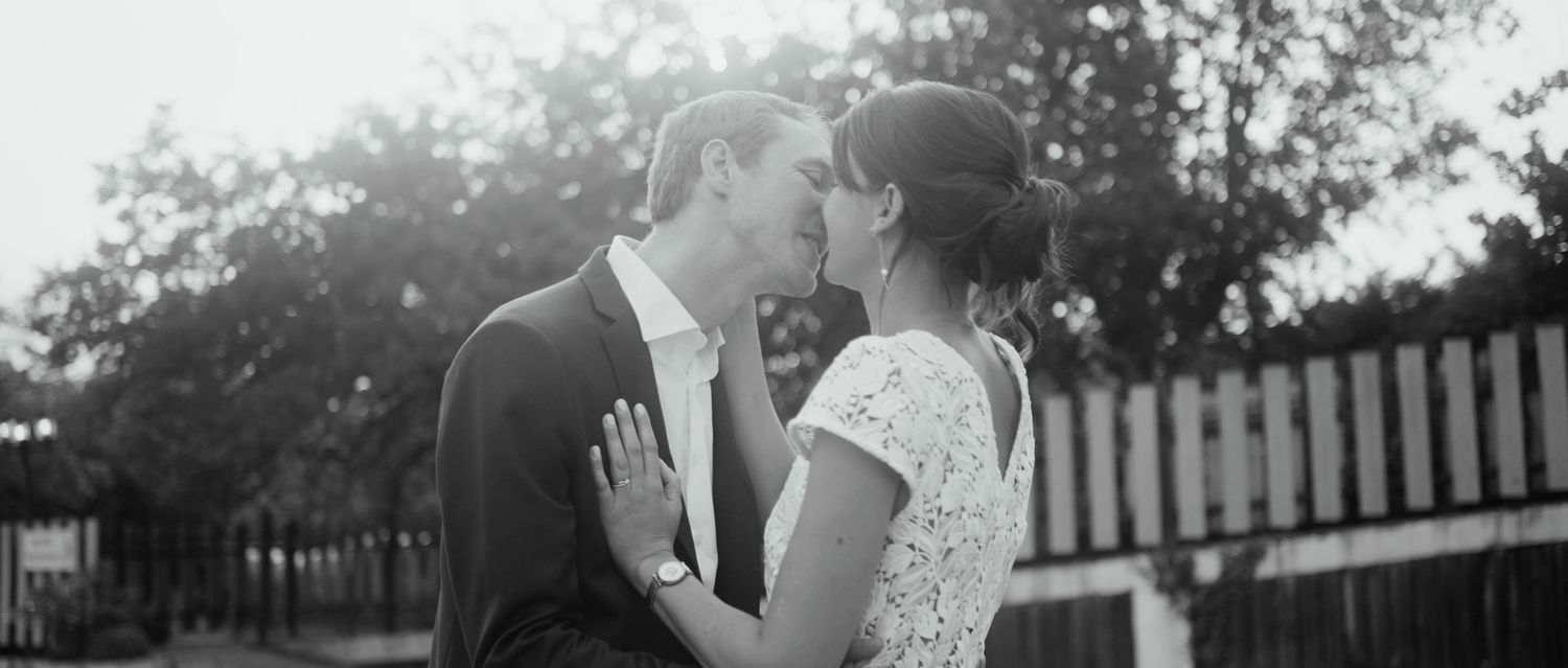 A black and white wedding photo collage showing romantic moments between newlyweds in an outdoor garden setting.