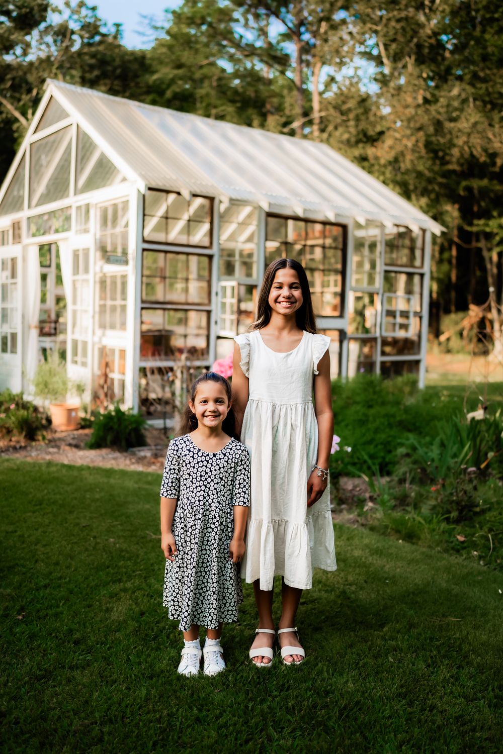 A series of photos showing white dresses against the backdrop of charming greenhouse structures in a garden setting.