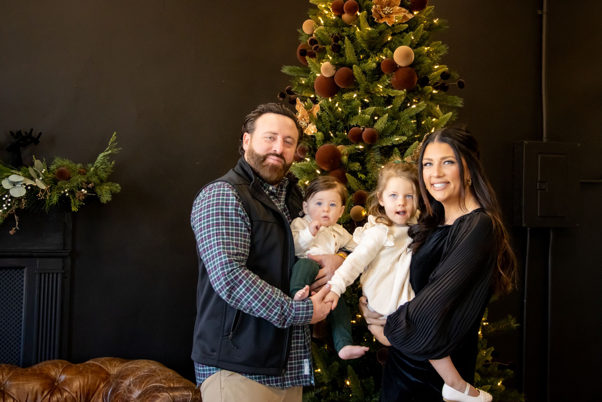 Cincinnati studio Christmas mini session family portraits with festive holiday backdrop and professional photography.