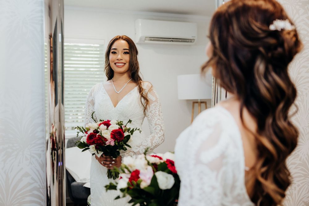 Wedding preparation scene with white floral bouquet and elegant bridal attire.