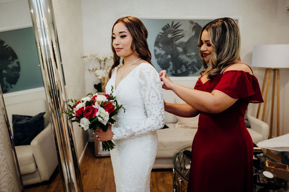 Wedding preparation scene with burgundy and white color scheme in an indoor setting.
