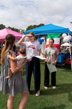Festival attendees participating in outdoor activities under colorful pop-up tents.