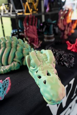 Row of mint green skeleton hand decorations displayed against black background.