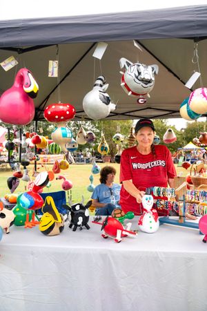 Vendor booth displaying colorful plush toys and stuffed animals at an outdoor market.