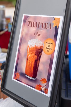 Framed photographs of Thai tea drinks arranged in a gallery-style display.