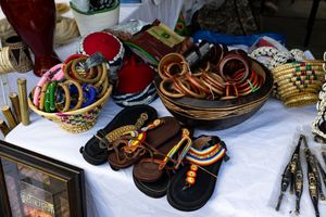 Display of colorful handcrafted Native American jewelry and crafts laid out on a white tablecloth.