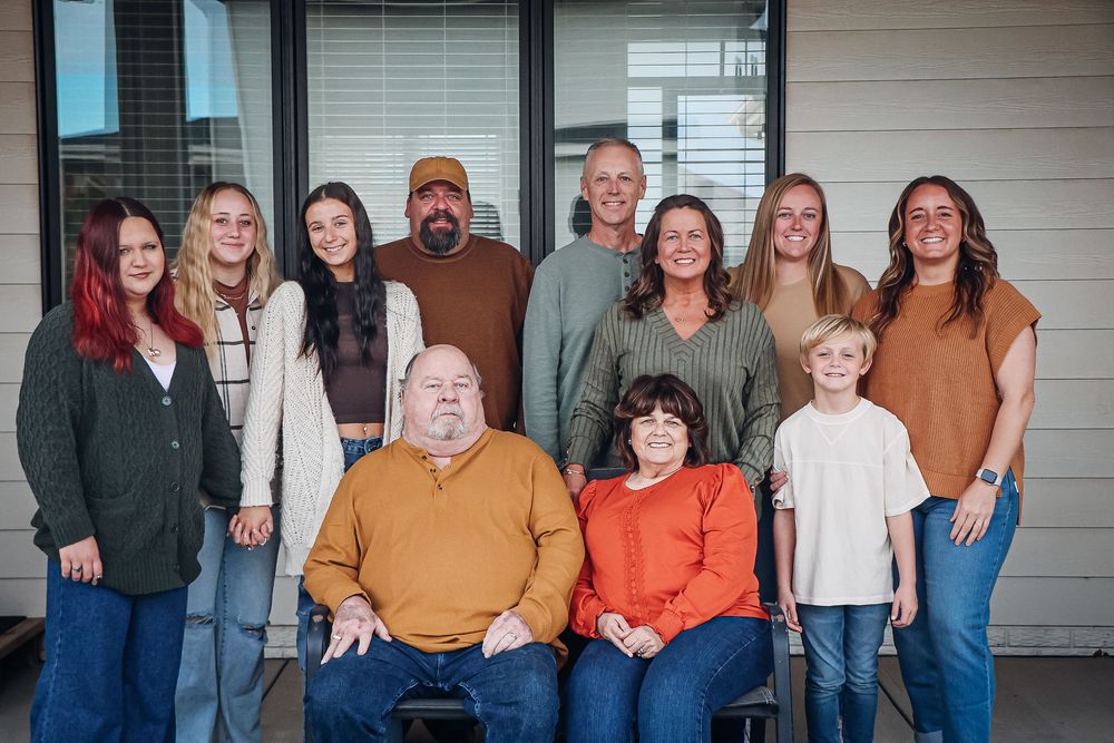 Large family group portrait on front porch of house. Extended family photography