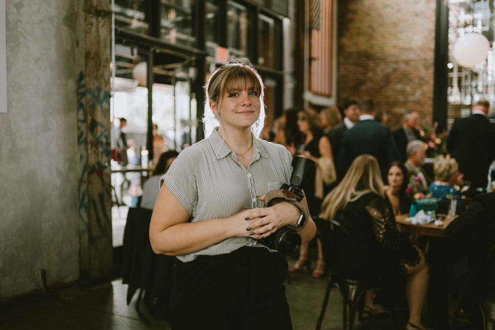 Dimly lit industrial-style venue with exposed brick walls and ambient lighting.