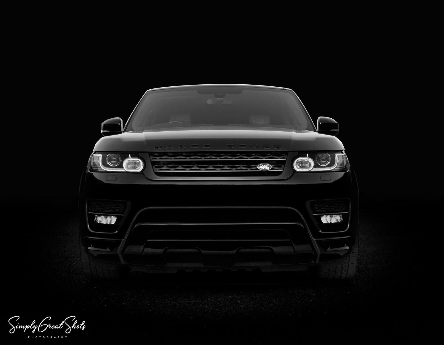 A black and white automotive image of a V8 Supercharged Range Rover