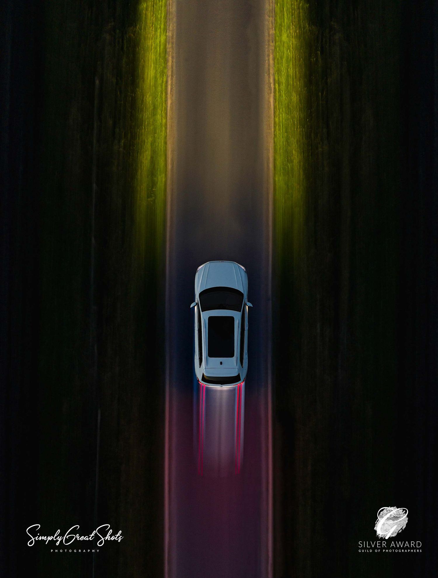A fusion of aerial and automotive photography of a white VW Tiguan driving at night.