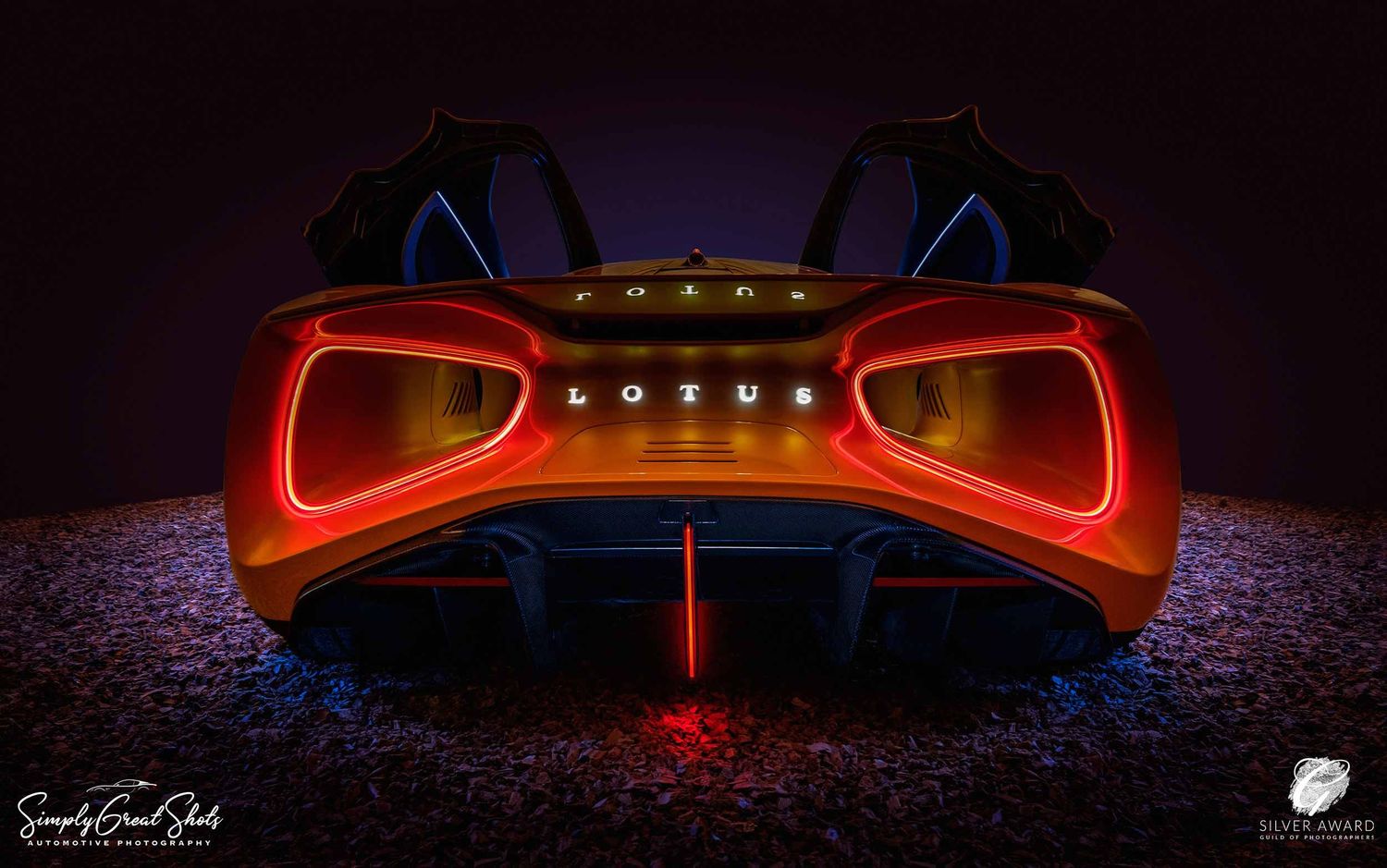 A photograph of the stunning rear view of a Lotus Evija supercar.