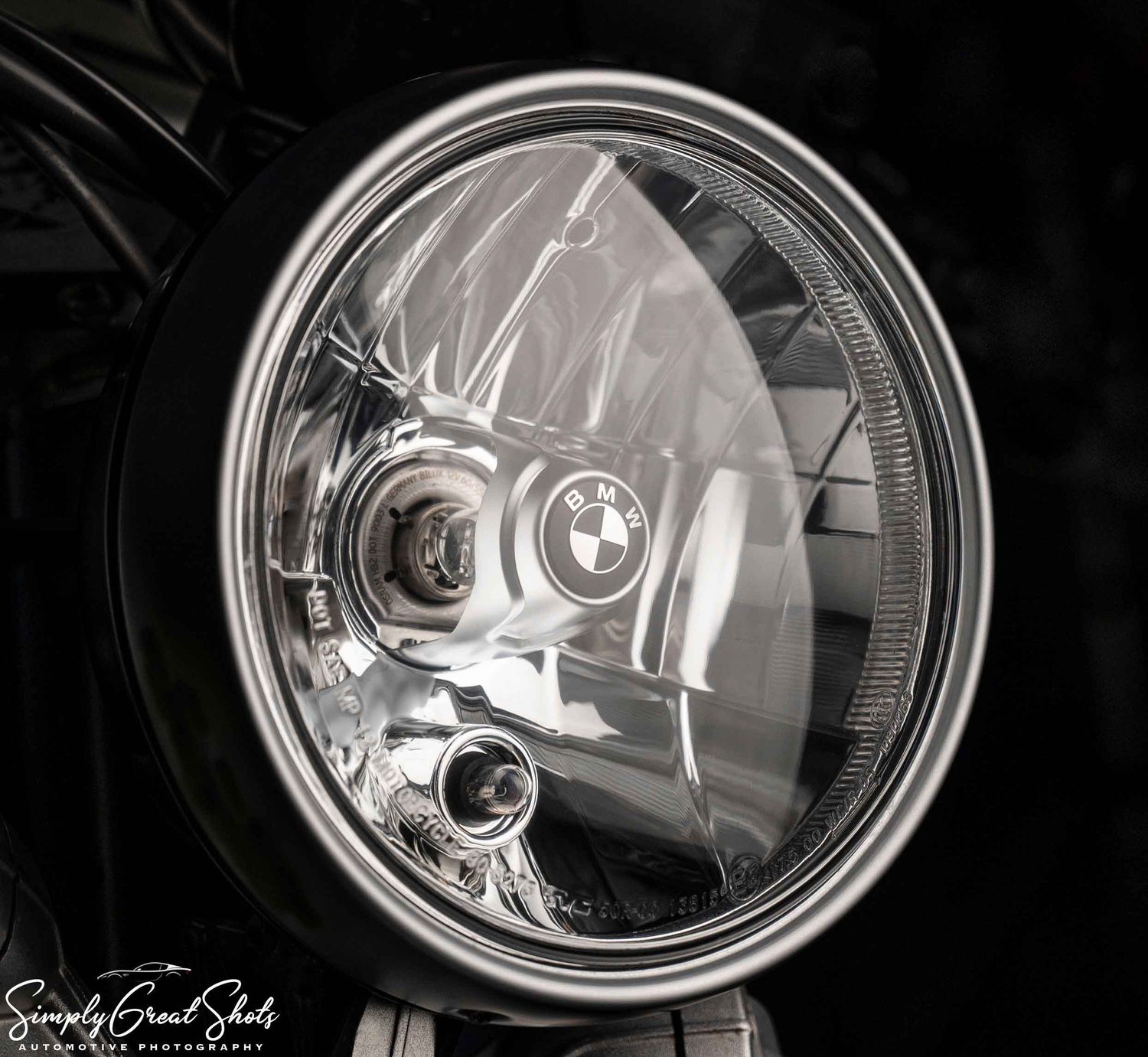 A detailed headlight photograph of a BMW motorcycle.