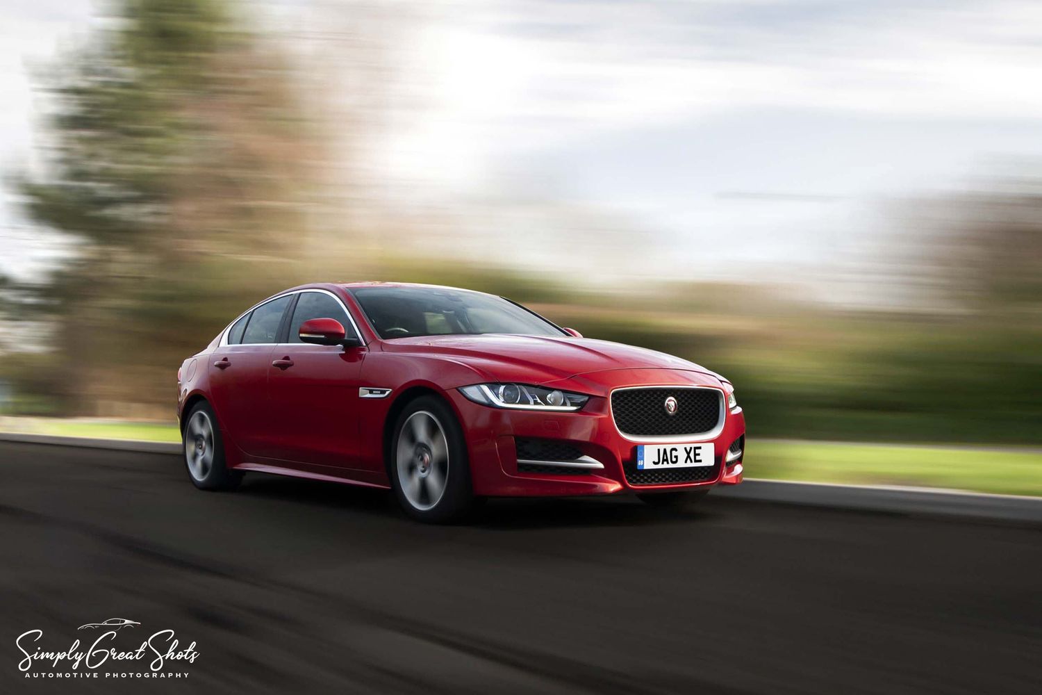 A red Jaguar XE rolling rig shot - Car photography