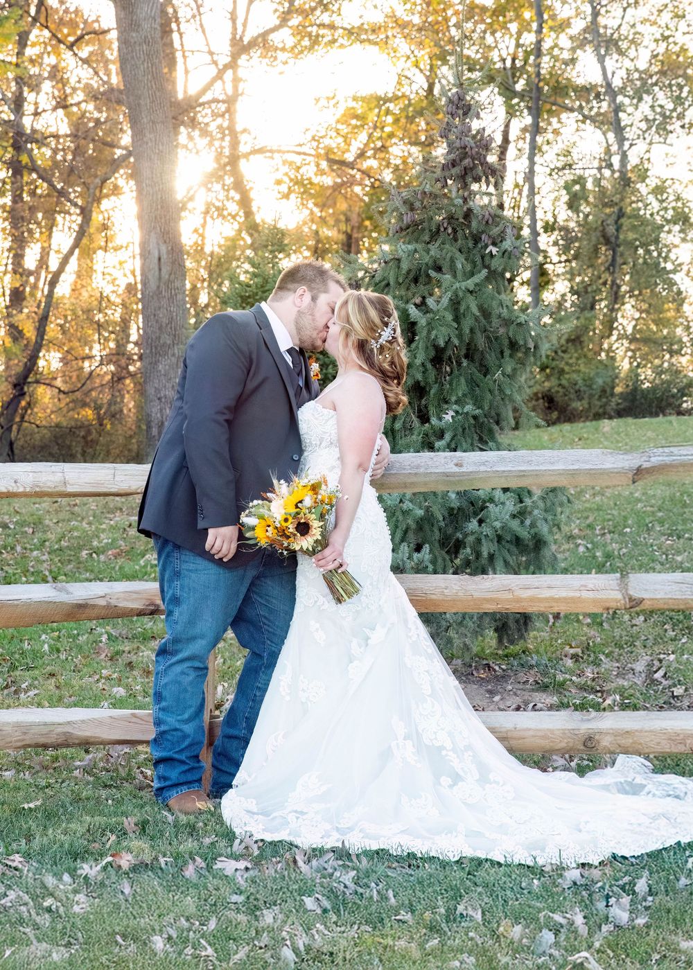 A romantic outdoor wedding photo series showing the couple embracing by a rustic wooden fence at sunset.