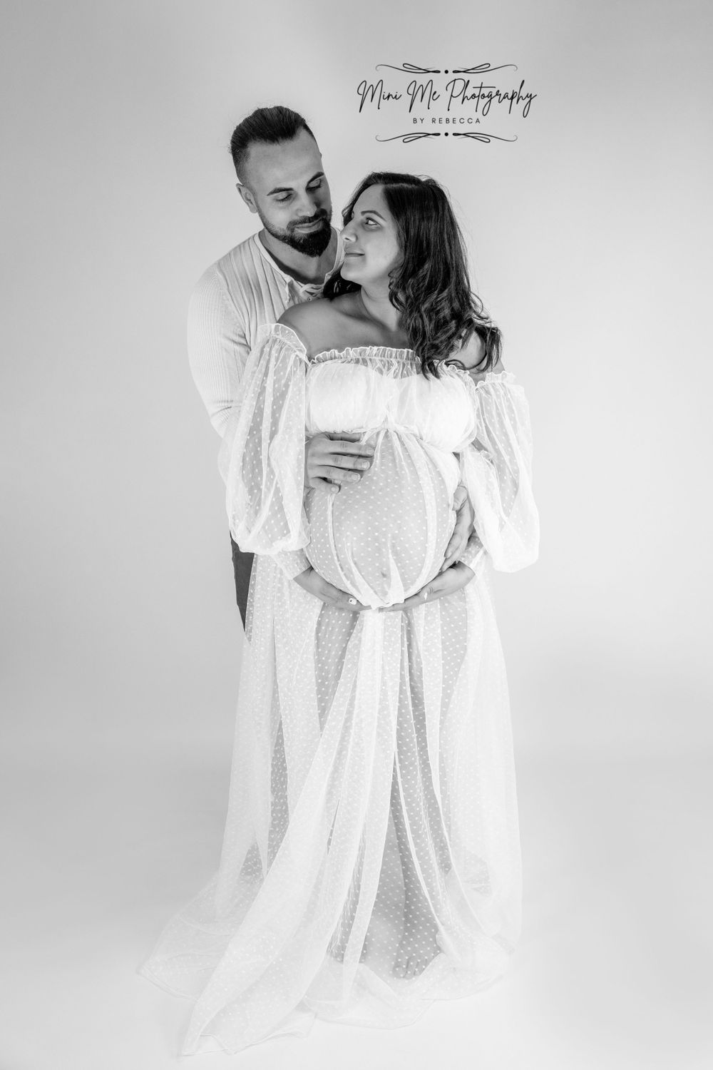Professional Maternity photoshoot standing hugging with partner