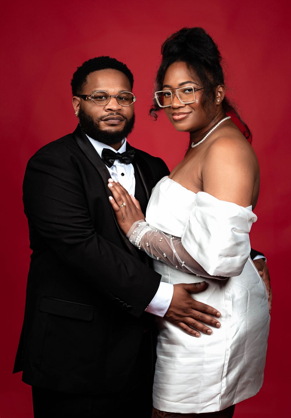 A romantic wedding photoshoot sequence showing a couple embracing against a deep red backdrop.
